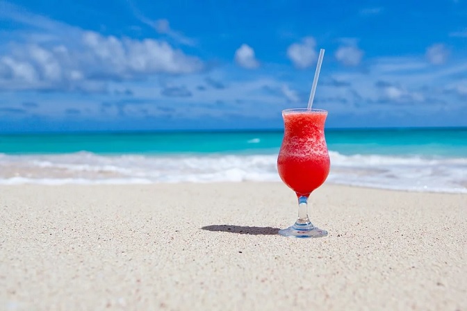 Cocktail drink on beach with blue sky